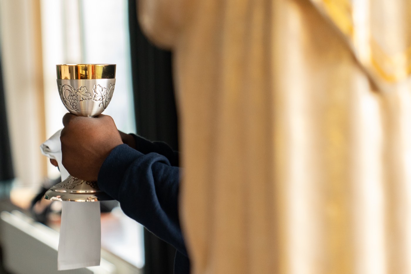 Sacramental preparation — Eucharistic chalice raised during Mass